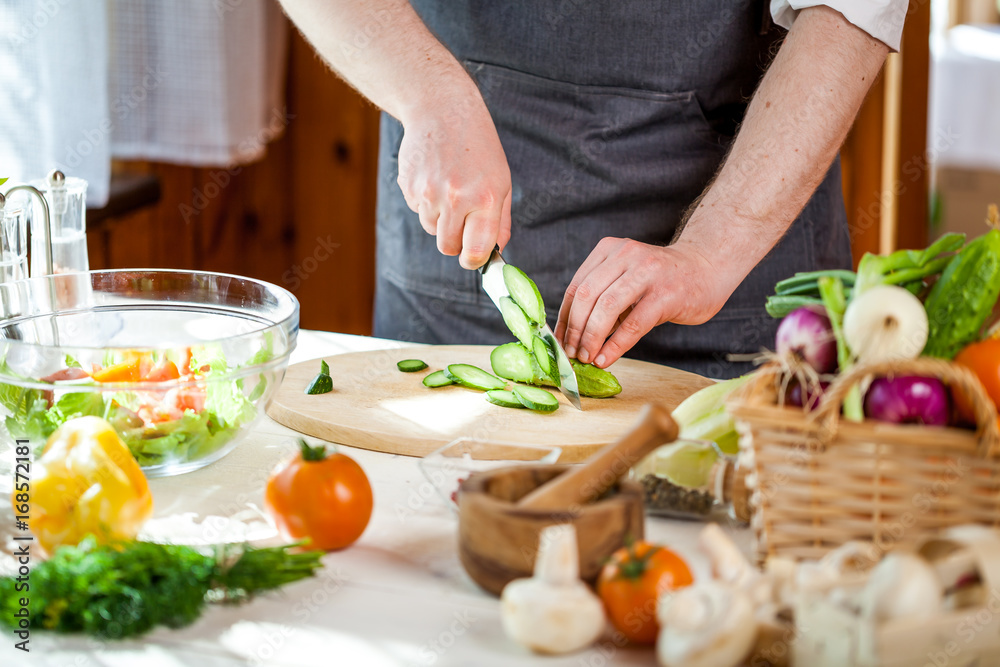 Chef cutting fresh and delicious vegetables for salad