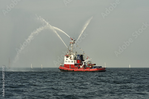 Fireboat, pumps a stream of water - shows for watchers