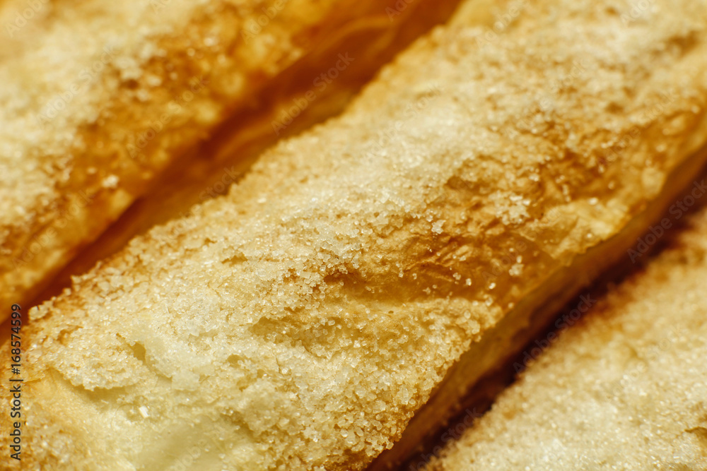 Puff pastry cakes with sugar powder close up