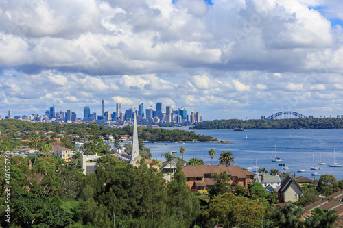 A view of Watsons Bay and the distant skycrapers of Sydney' CBD, Water with Yacht, Harbour Bridge and Cityscape in background © CHATCHAI