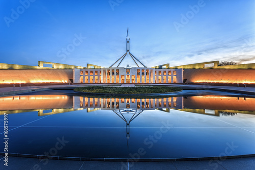 Dramatic evening sky over Parliament House, illuminated at twilight. Which was the world's most expensive building when it was completed in 1988 in Canberra, Australia photo