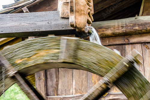 Water mill, detail with unsharpness by movement of the wheel photo