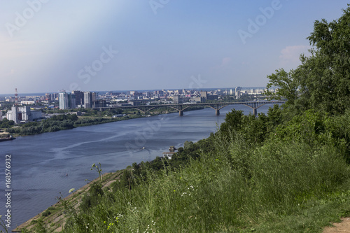 View of the Oka river and the lower part of the city. Nature landscape, city, and house, the bridge connecting the two shores.