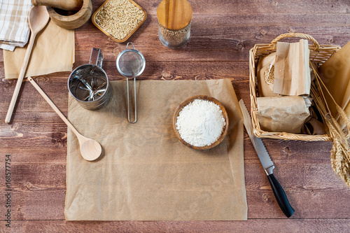 wheat and flour on rustic wooden table, top view, copy space