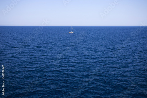 Sailing boat on horizon