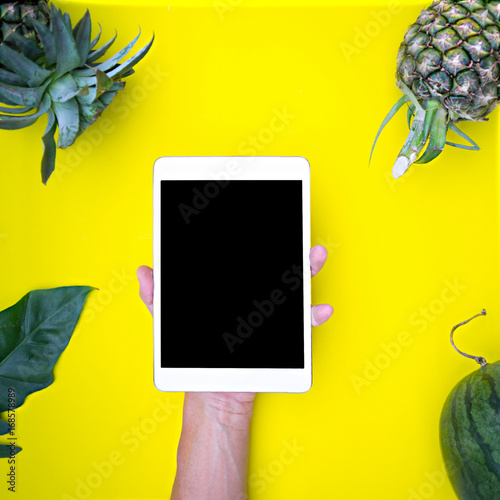 Flat lay hand using tablet on top view,background in pastel colors.clipping path inside