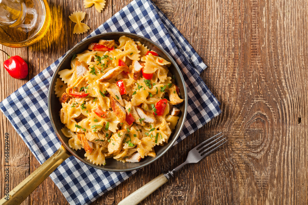 Pasta farfalle with chicken and paprika, in carbonara sauce. Pasta farfalle with chicken and paprika, in carbonara sauce.