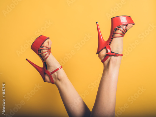 Woman with red stripper heels in the air photo