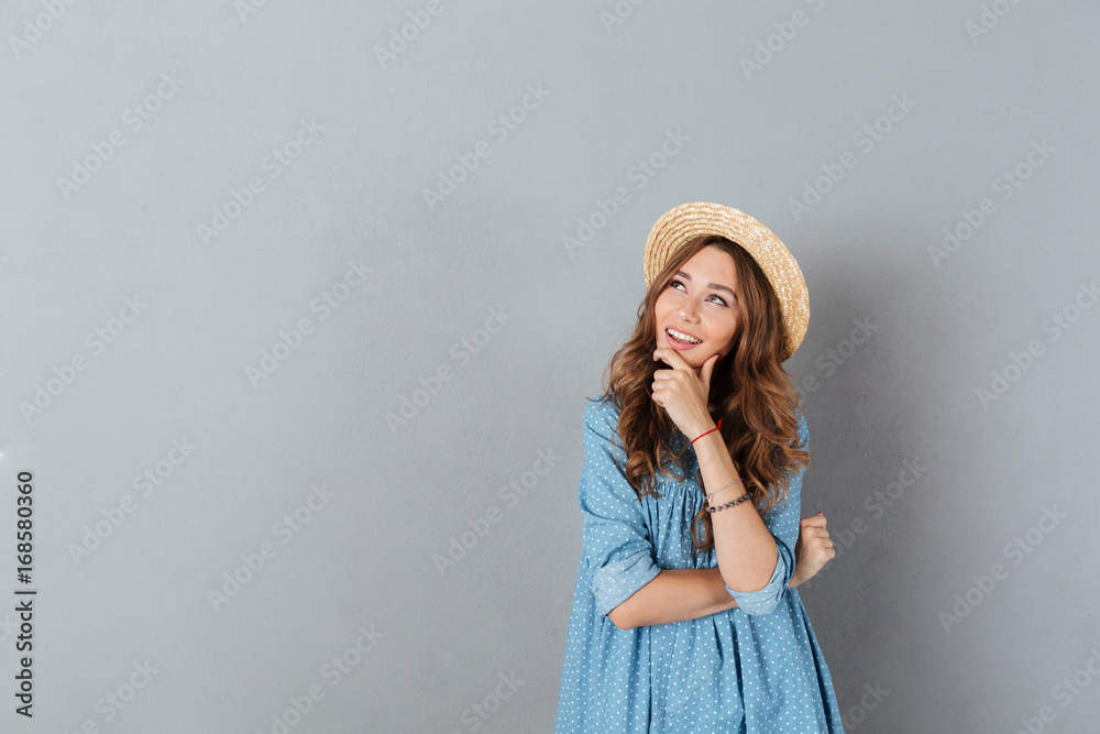 Cheerful young pretty woman standing over grey wall Cheerful young pretty woman standing over grey wall