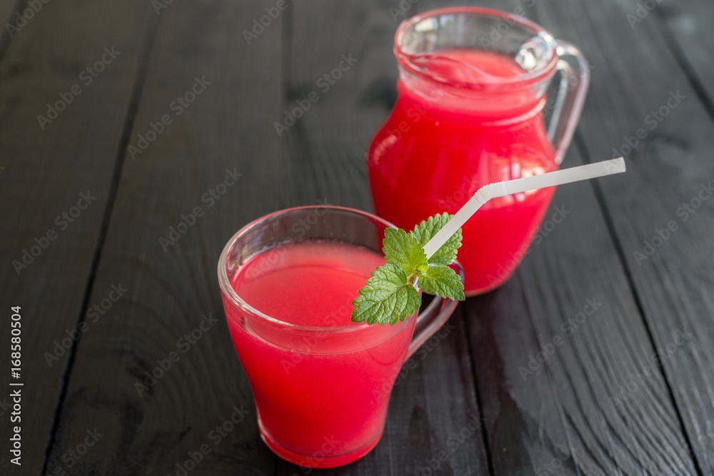 Watermelon juice on a wooden table. It can be used as a background Watermelon juice on a wooden table. It can be used as a background