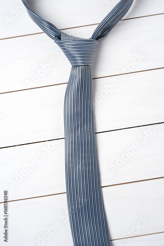 Blue necktie on an old wooden table. Close up