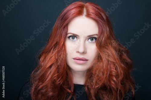 Gorgeous young woman with amazing full redhair