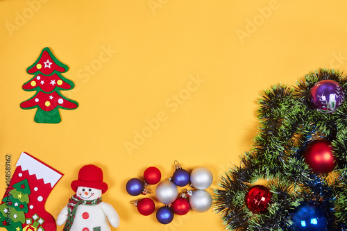 Flat lay of Christmas decoration on yeallow background