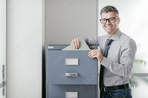 Office clerk searching files photo