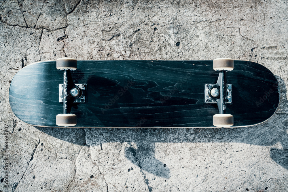 Skateboard on concrete floor in skatepark