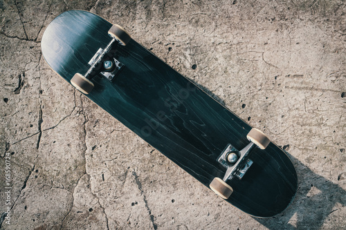 Skateboard on concrete floor in skatepark