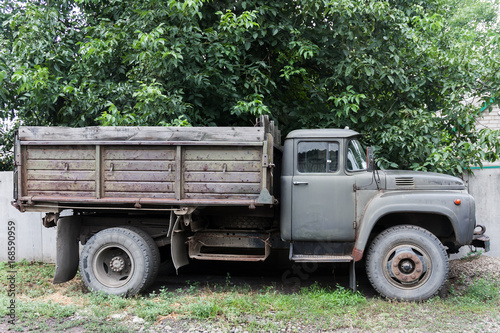 Old rusted soviet truck near the fence