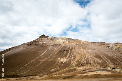 Mudpot in the Namafjall geothermal area  Iceland - area around boiling mud is multicolored and cracked