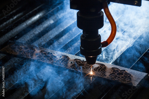 Laser makes engraving on leather belt photo