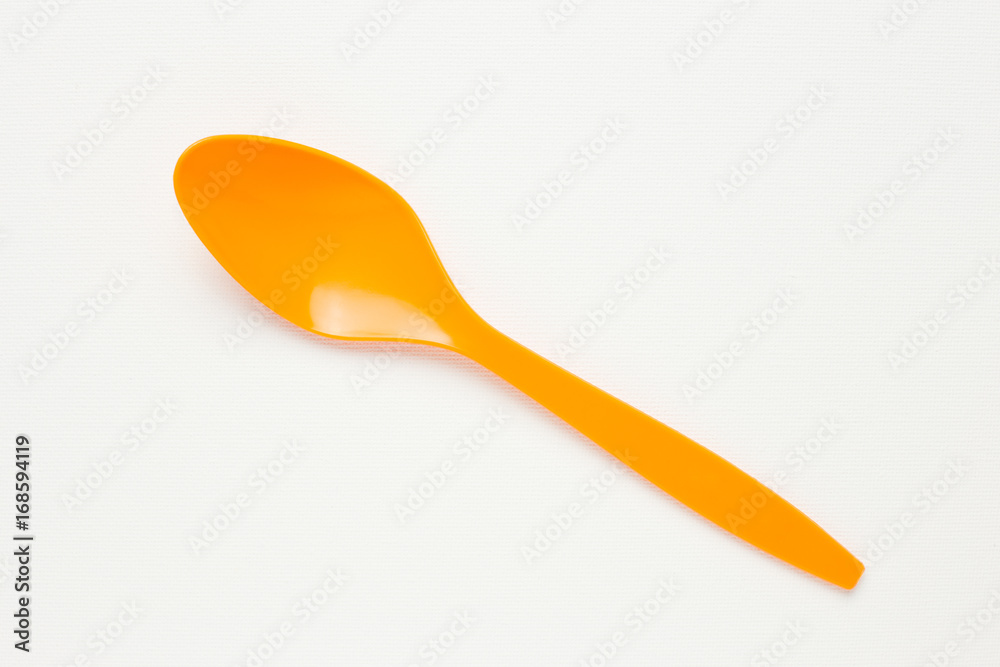 Orange spoon on white canvas background Orange spoon on white canvas background