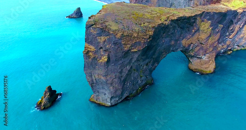 Huge Sea Arch In Turquoise Blue Ocean - Aerial Footage of Dyrholaey Sea Arch in Iceland