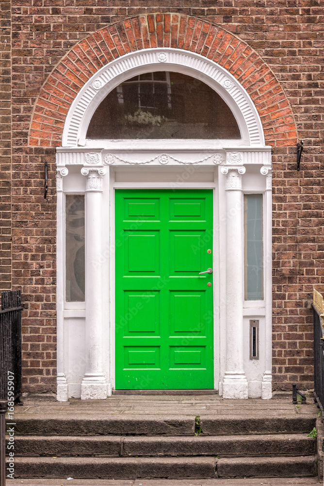 Green classic door in Dublin, example of georgian typical architecture of Dublin, Ireland