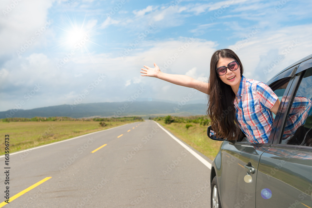 female traveler in car window wearing sunglasses female traveler in car window wearing sunglasses