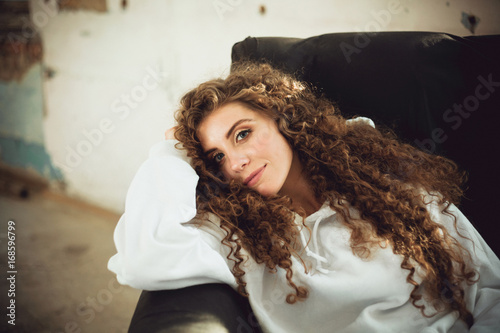 Beautiful stylish woman with curly hair in white sweatshirt © Amelia Fox