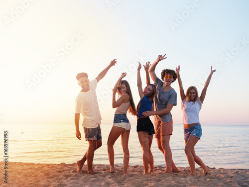 Group of friends having fun on the beach