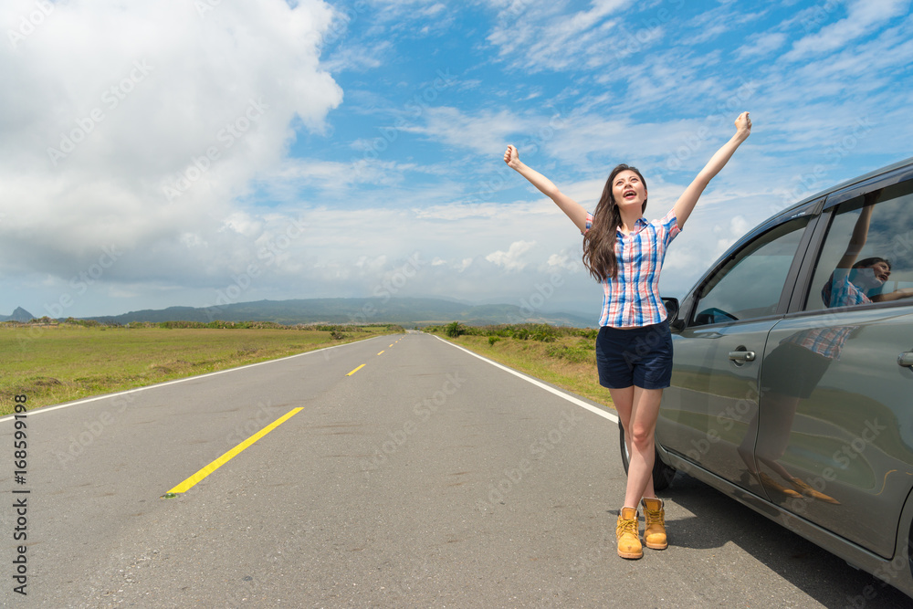 female traveler stopping car on asphalt roadside