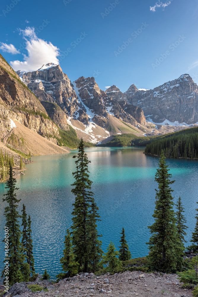 Moraine lake with snow-covered peaks at sunset in Banff National Park of Canada