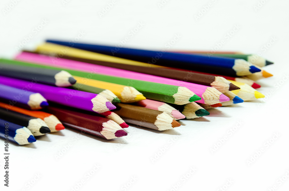 Colored pencils on white background. Close-up. Colored pencils on white background. Close-up.