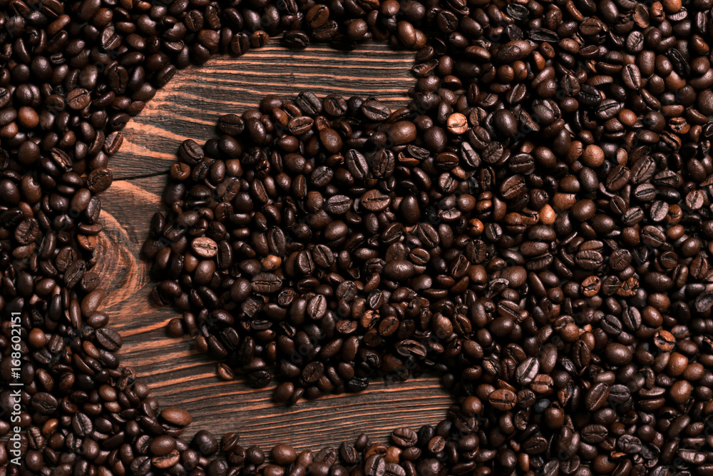Letter C inscription with coffee bean on the wooden table Letter C inscription with coffee bean on the wooden table