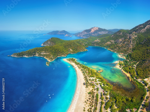 Fototapeta Naklejka Na Ścianę i Meble -  Amazing aerial view of Blue Lagoon in Oludeniz, Turkey. Summer landscape with mountains, green forest, azure water, sandy beach and blue sky in bright sunny day. Travel background. Top view. Nature