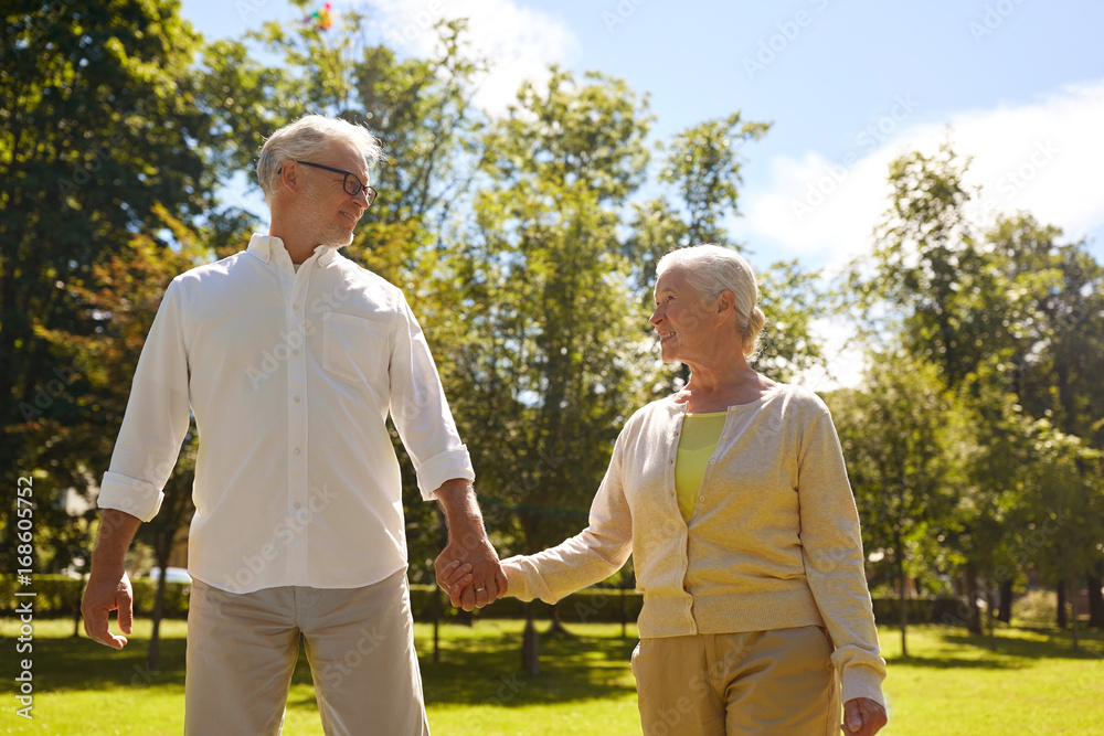 happy senior couple walking at summer city park happy senior couple walking at summer city park