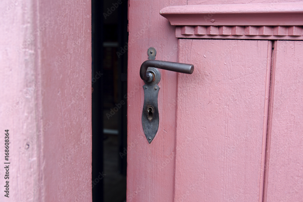 closeup of red door with old doorhandle