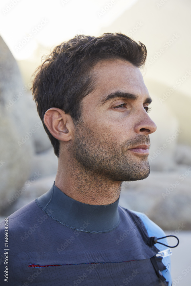 Fototapeta premium Handsome wetsuit guy in profile, looking away