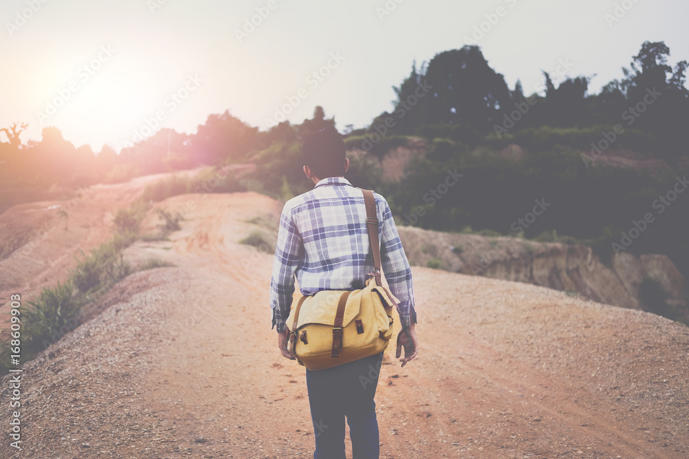 Hipster with backpack enjoying hiking at mountian with beautiful of sunset, vintage tone