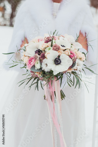 Wedding bouquet in hands of the bride