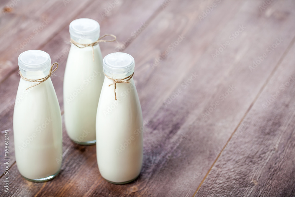 bottles of milk on a wooden rustic table. copy space bottles of milk on a wooden rustic table. copy space