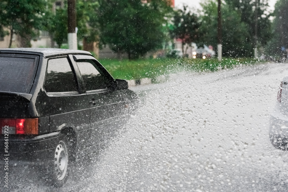 Fototapeta premium car rain puddle splashing water