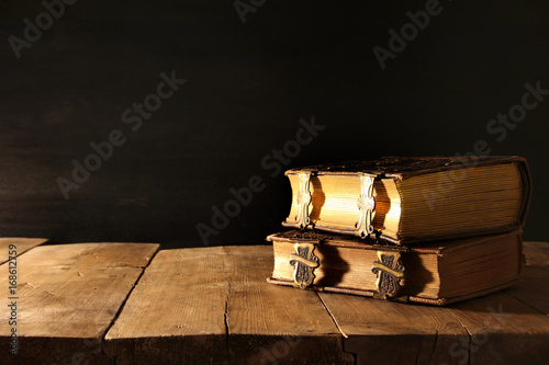 Image of antique books, with brass clasps on old wooden table
