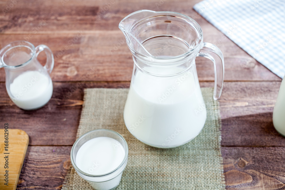 milk and glasses of milk on a wooden rustic table. milk and glasses of milk on a wooden rustic table.