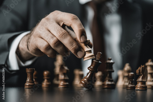 businessman and chess figures on table