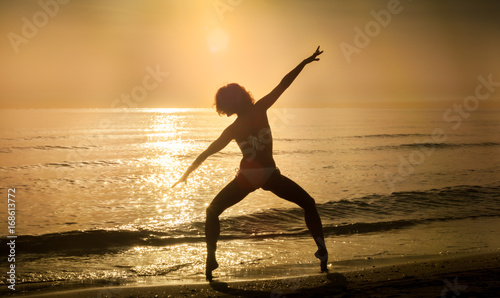  woman practicing dancing in the beach