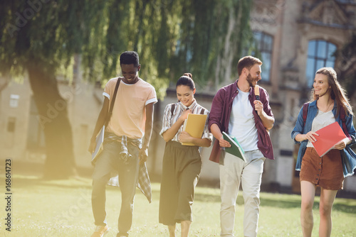 multicultural students walking in park