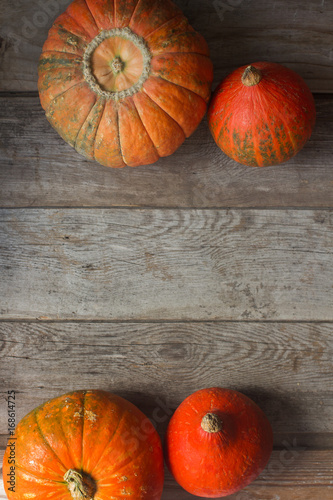 Organic ogange pumpkins on wooden table, thanksgiving pumpkin background, autumn harvest photo