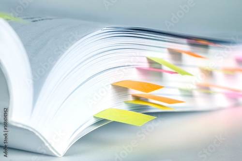 Close up White book marked by sticky note photo