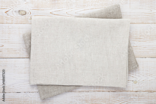 Napkin white. Stack of grey dish towels on white wooden table background top view, mock up.