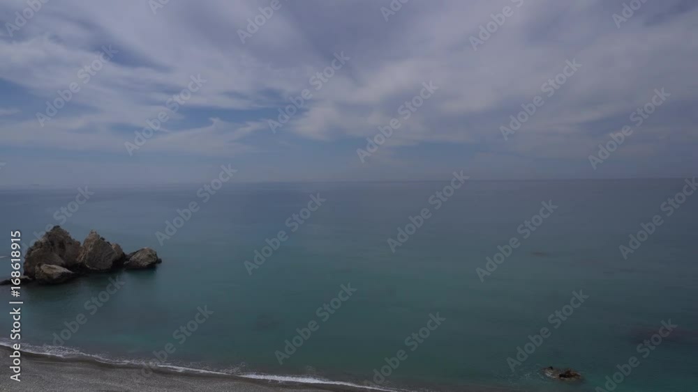 Panning shot of tuquoise sea and cloudy sky from high cliff Panning shot of tuquoise sea and cloudy sky from high cliff